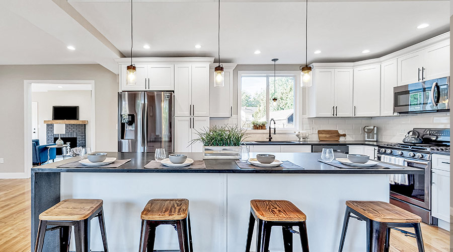 kitchen with stools at island and white cabinets monson ma